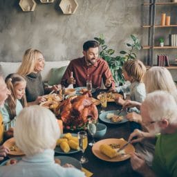 A large family enjoying dinner for the holidays.