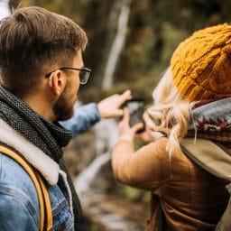 Young couple hiking. Man is wearing hearing aids.