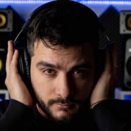 Man holds headphones over ears