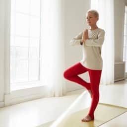 Senior woman balancing on one foot