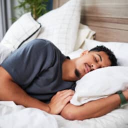 Young Man Peacefully Sleeping in a Comfortable Bed on a Quiet Morning