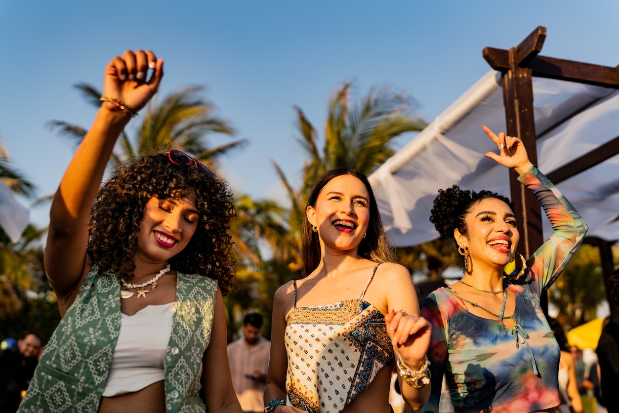 Young friends dancing during party outdoors.