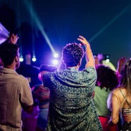 A group of people dancing at a concert.