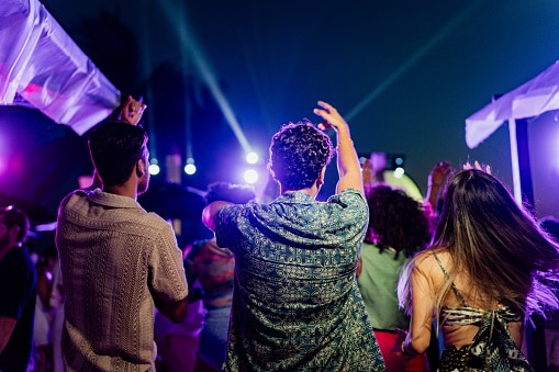 A group of people dancing at a concert.